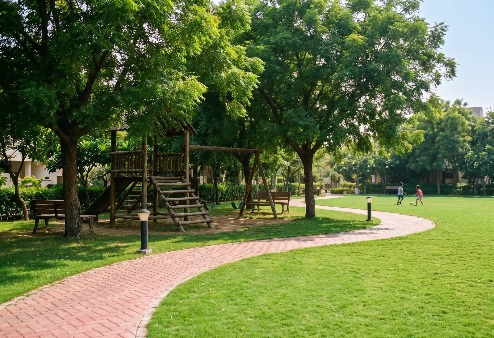 A landscaped park inside the layout with a lawn, a walking path, benches and young trees